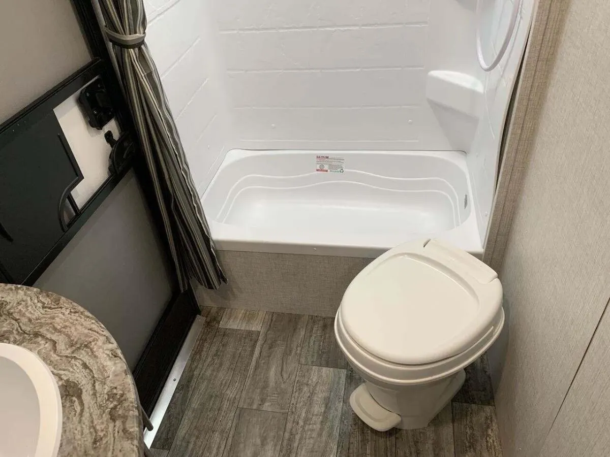 Bathroom with a sink, toilet and a walk-in shower.