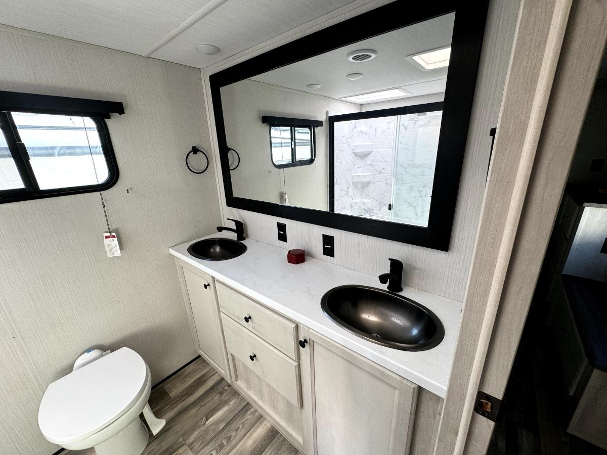 Bathroom with sinks and a toilet.