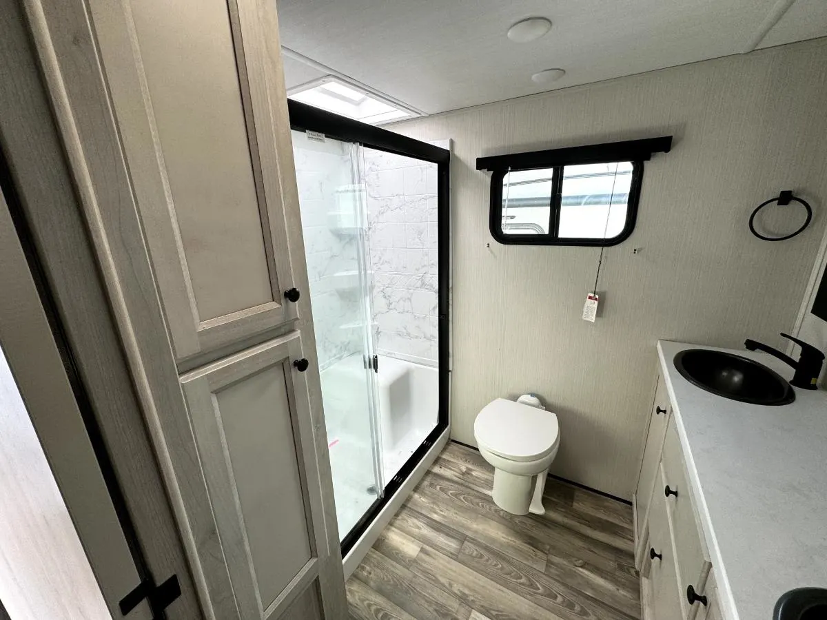 Bathroom with a sink, toilet and a walk-in shower.