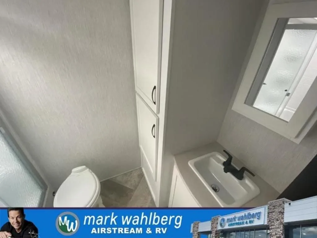 Bathroom with a sink, toilet and a walk-in shower.