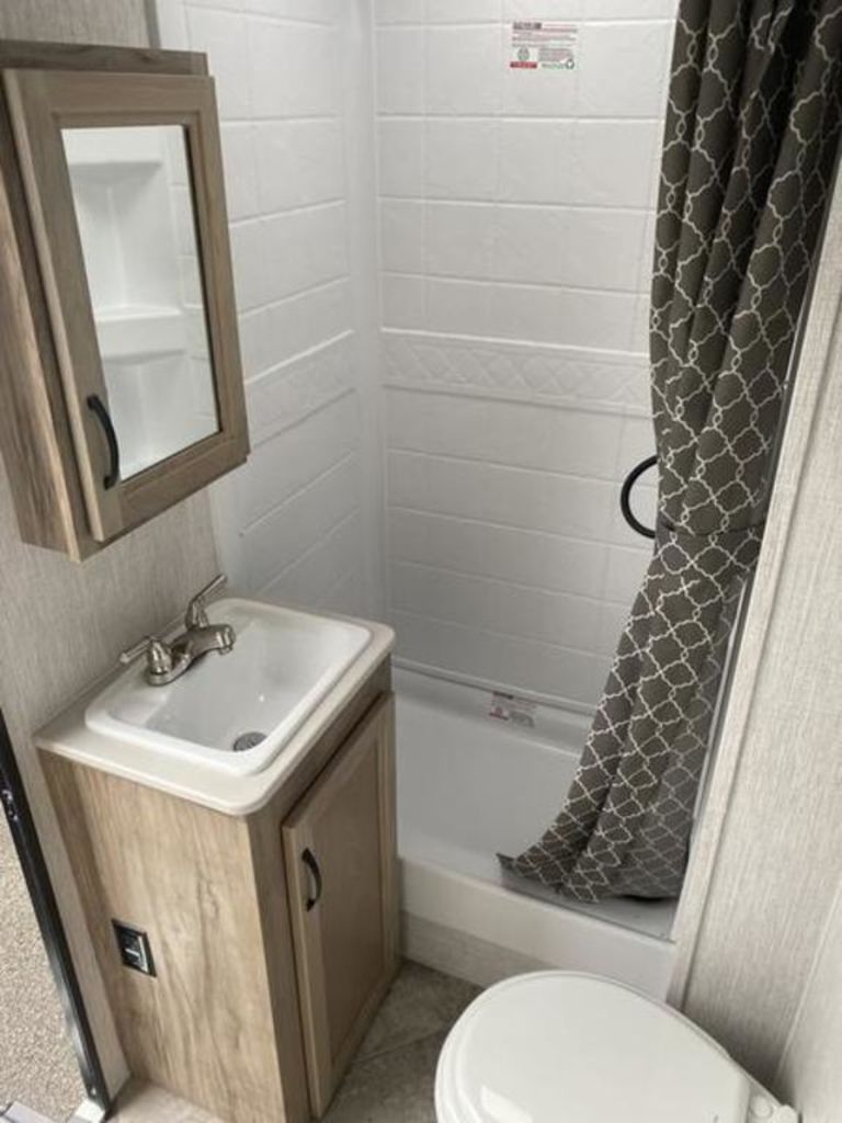 Bathroom with a sink, toilet and a walk-in shower.