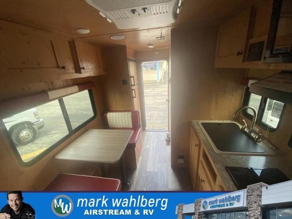 Interior view of the RV with a dinette and a kitchen.