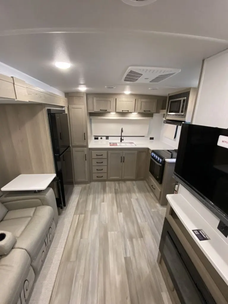 Interior view of the RV with a living space and a kitchen.