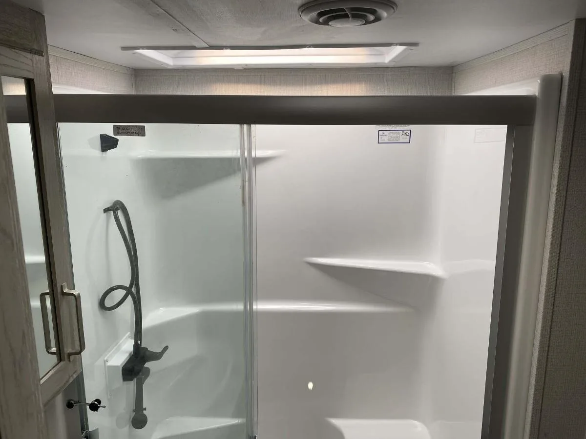 Bathroom with a walk-in shower and a skylight.