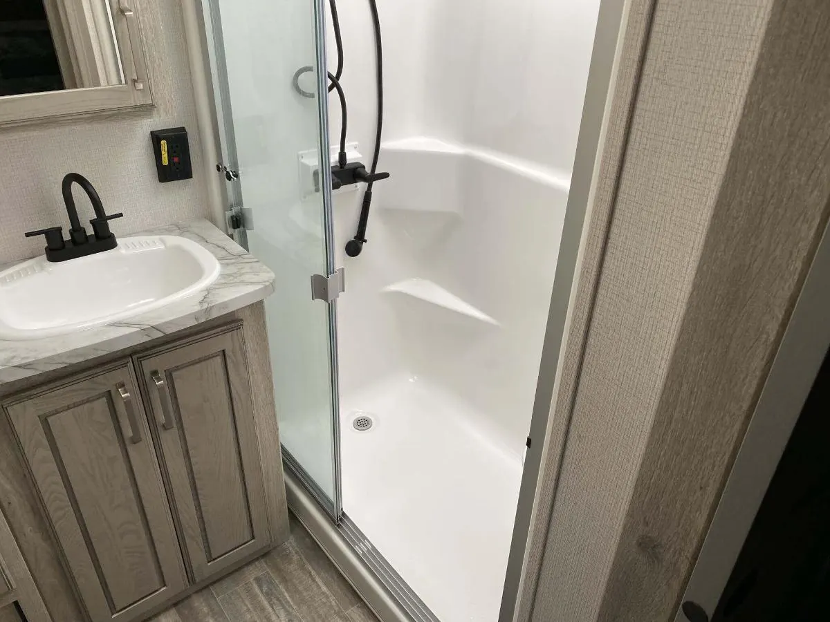 Bathroom with a sink and a walk-in shower.