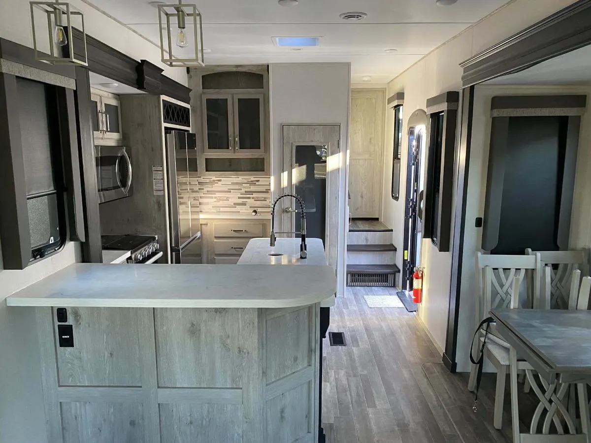 Interior view of the RV with a dinette and a kitchen.