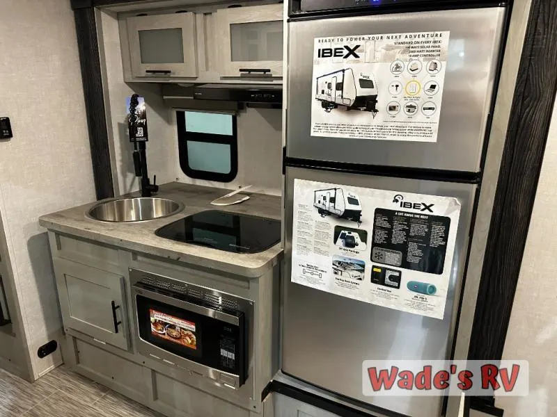 Kitchen with a gas range, fridge, sink and cabinets.