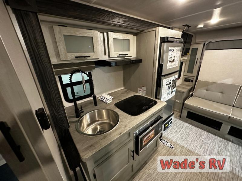 Kitchen with a gas range, fridge, sink and cabinets.