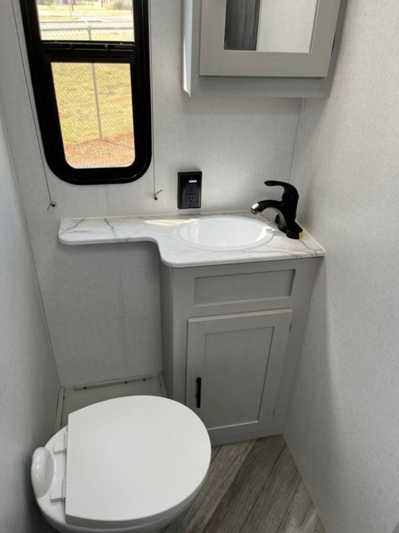 Bathroom with a sink, toilet and a medicine cabinet.