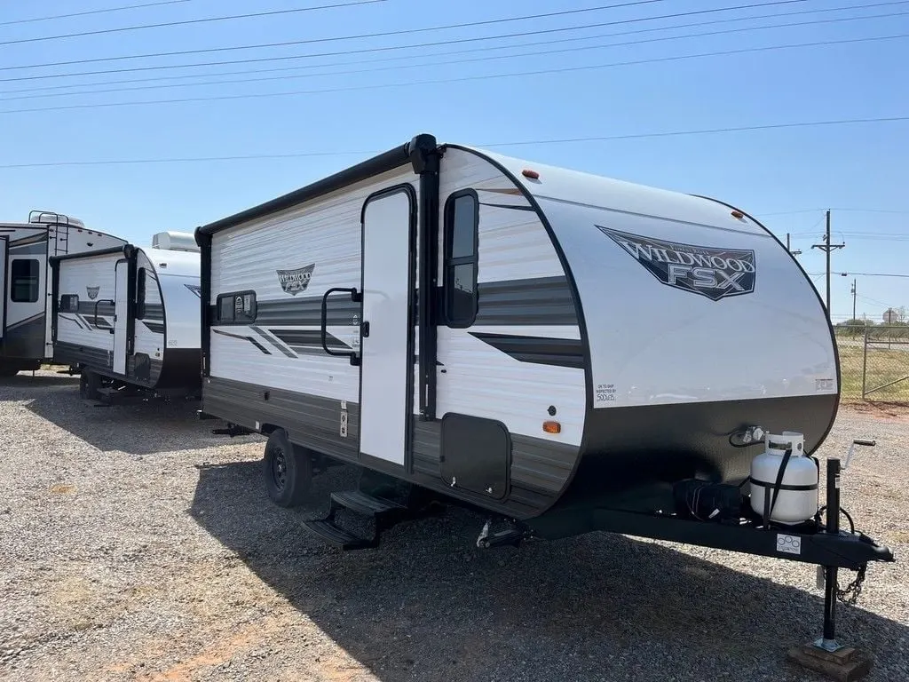 Side view of the New 2022 Forest River Wildwood FSX Northwest 169RSK Travel Trailer RV.