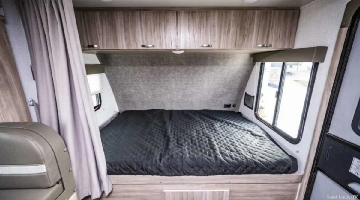 Bedroom with overhead cabinets.