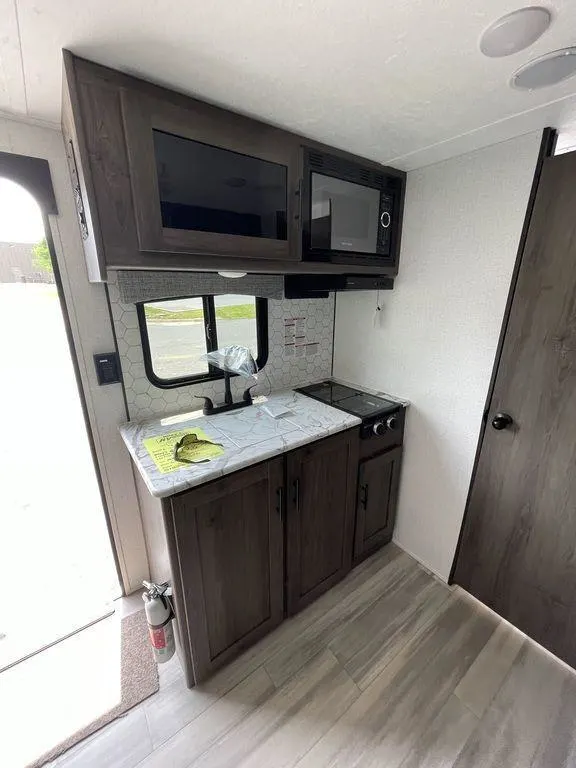 Kitchen with a gas range, oven, sink and cabinets.