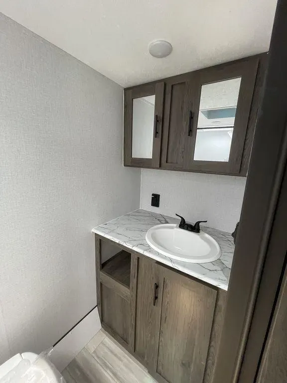 Bathroom with a sink, toilet and a medicine cabinet.