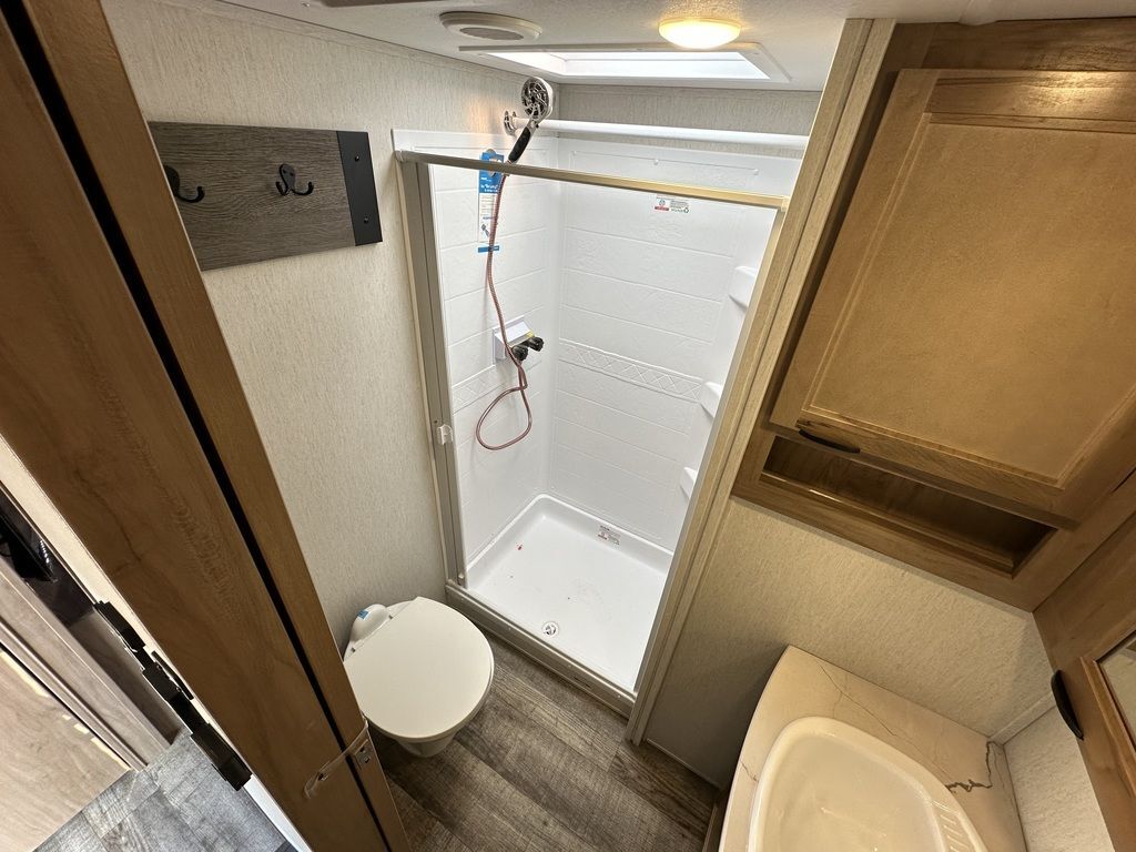 Bathroom with a sink, toilet and a walk-in shower.