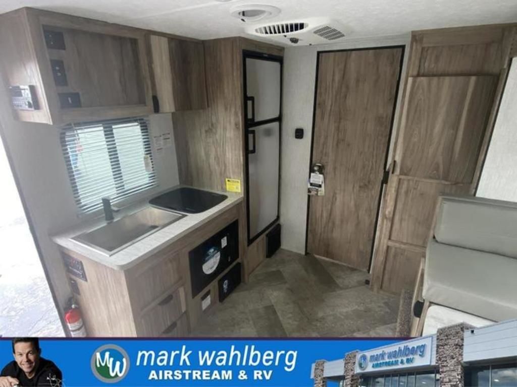 Kitchen with a gas range, fridge, sink and cabinets.