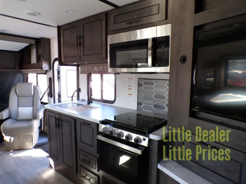 Kitchen with a gas range, oven, sink and cabinets.