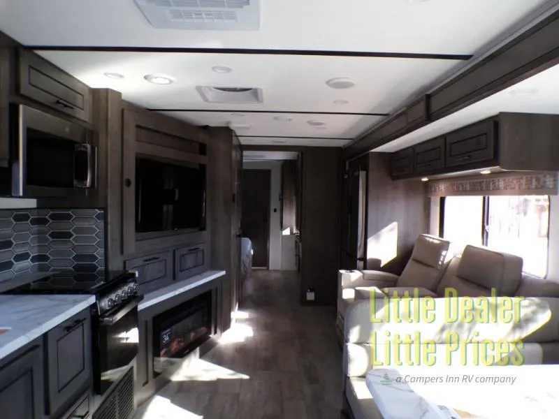 Interior view of the RV with a dinette, living space and a kitchen.