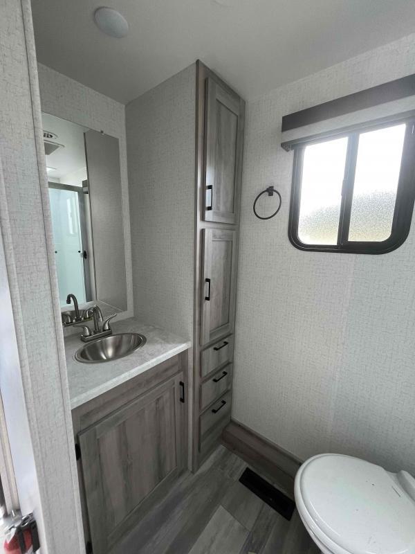 Bathroom with a sink, toilet and linen.