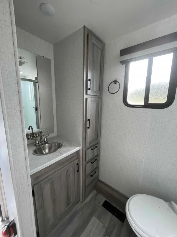 Bathroom with a sink, toilet and linen.