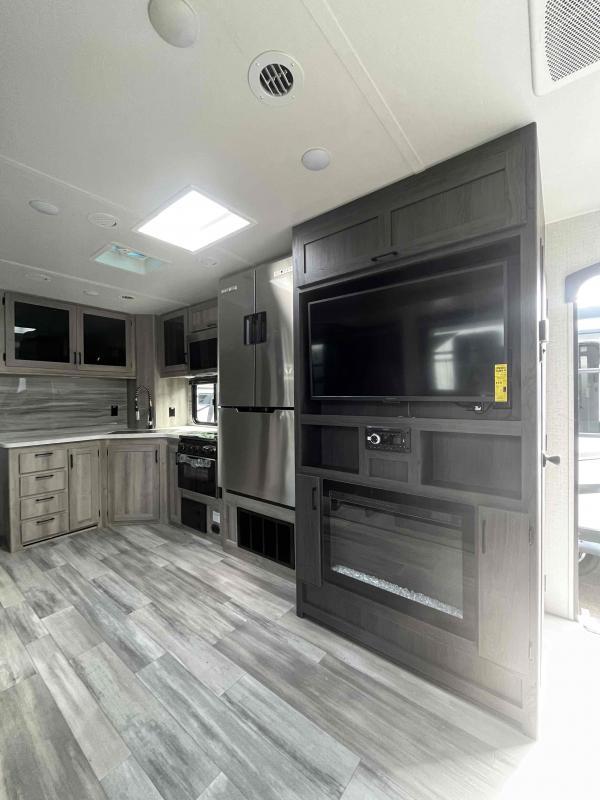 Entertainment center with a TV and a fireplace.