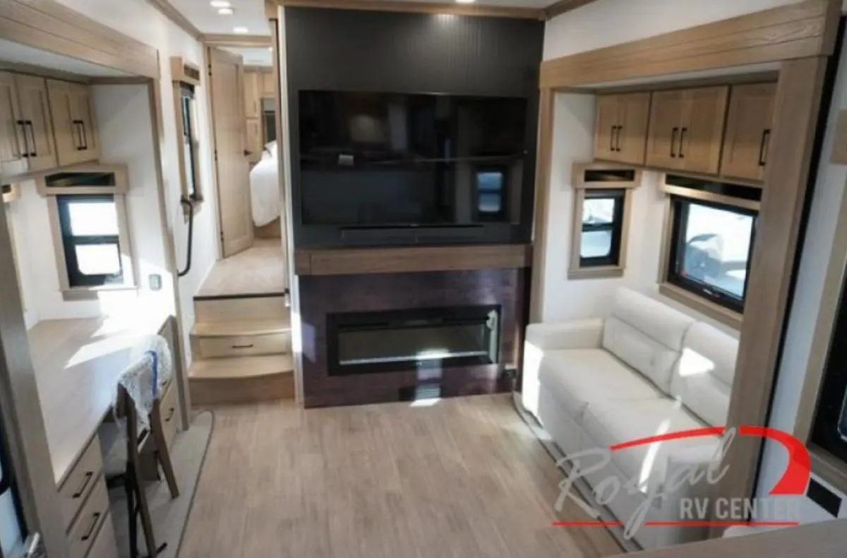 Living space with leather seats and an entertainment center.