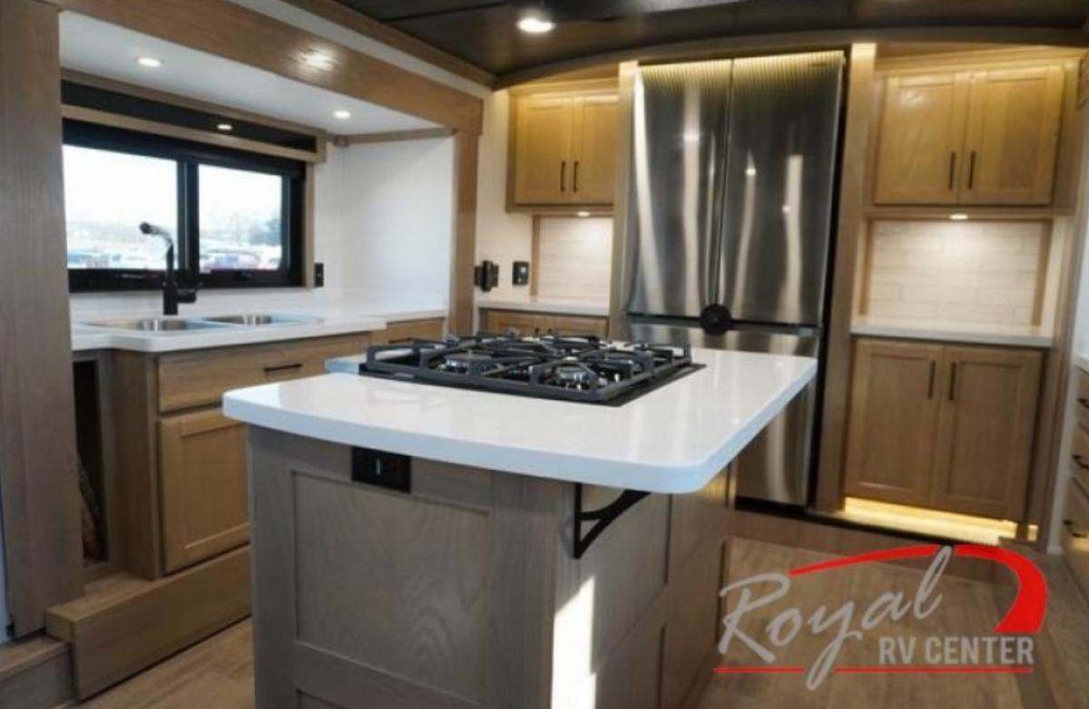 Kitchen with a gas range, fridge, sink and cabinets.