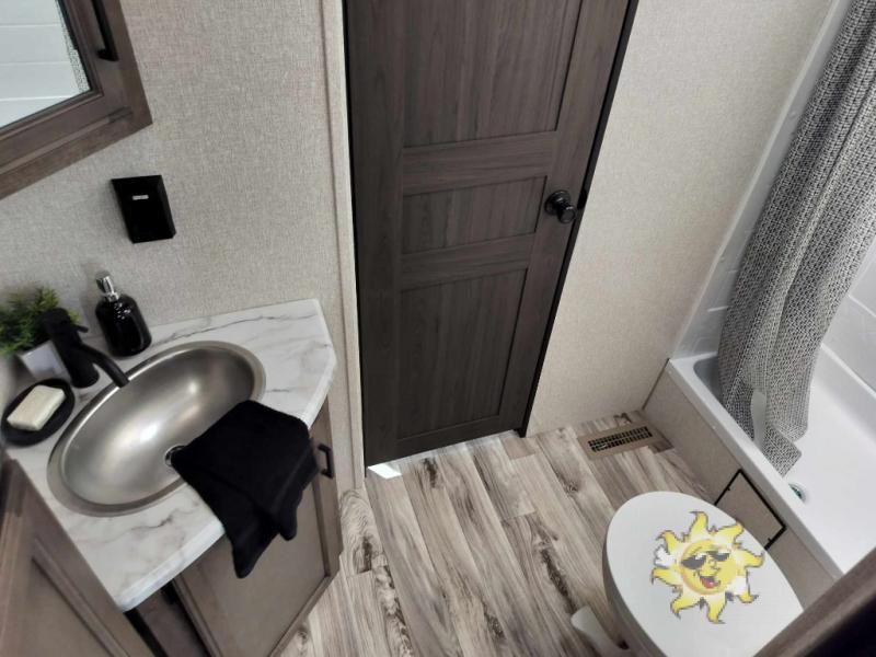 Bathroom with a sink, toilet and a walk-in shower.