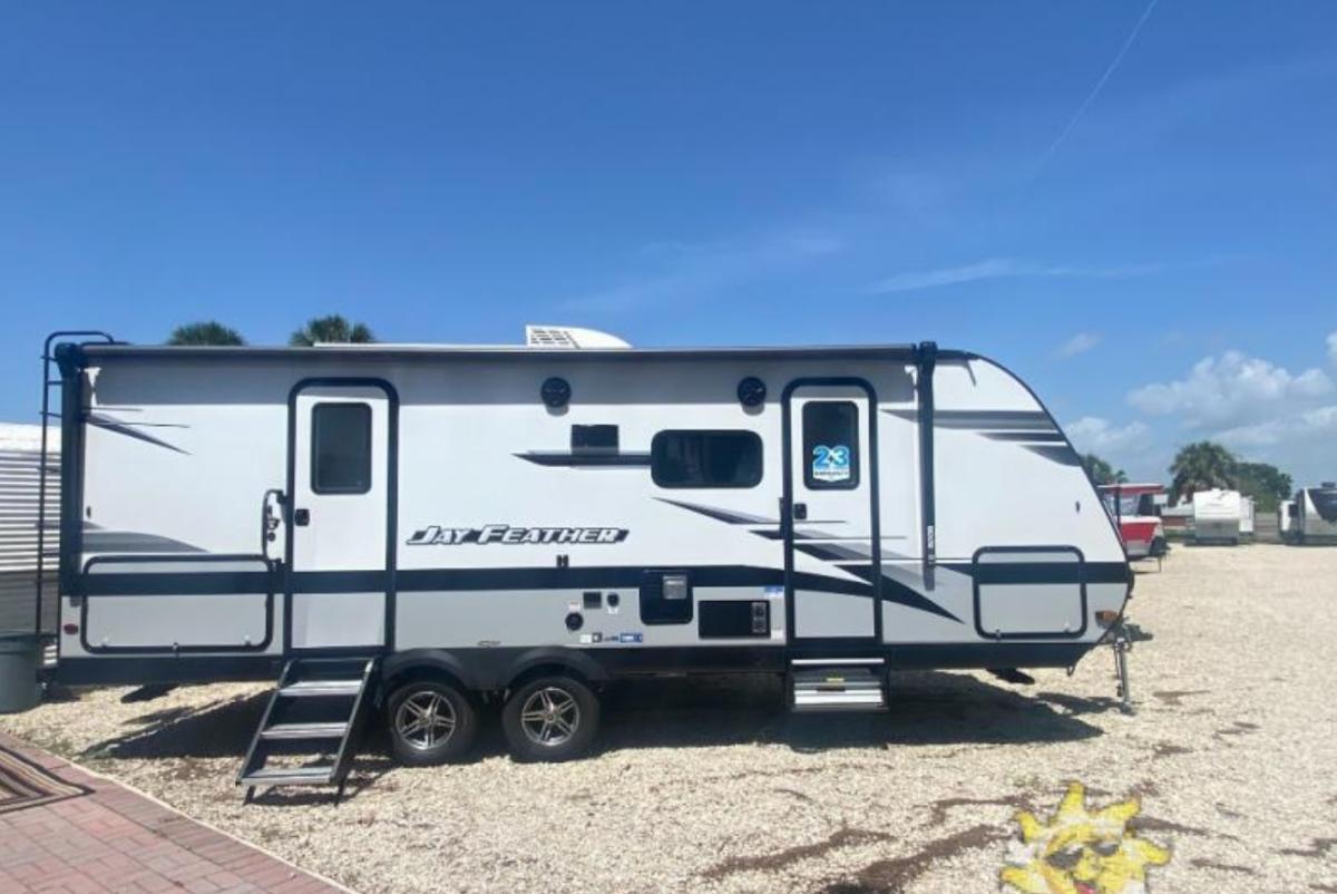 Side view of the New 2022 Jayco Jay Feather 22RB Travel Trailer RV.