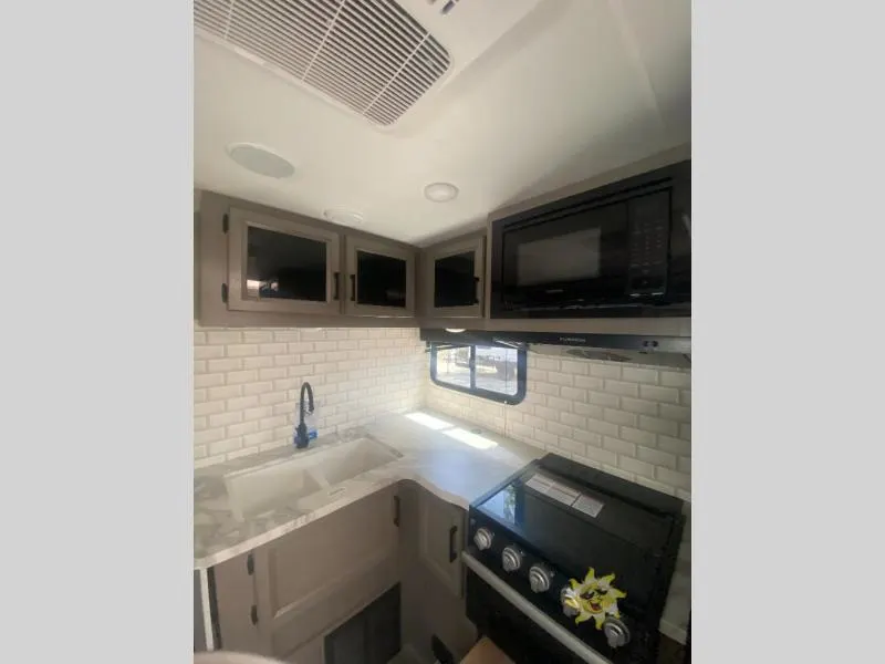 Kitchen with a gas range, oven, sink and cabinets.