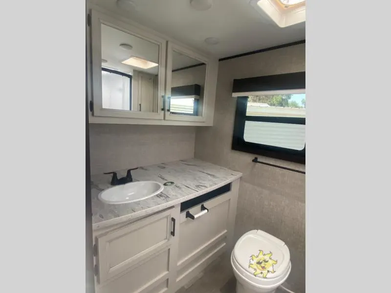 Bathroom with a sink, toilet and a medicine cabinet.