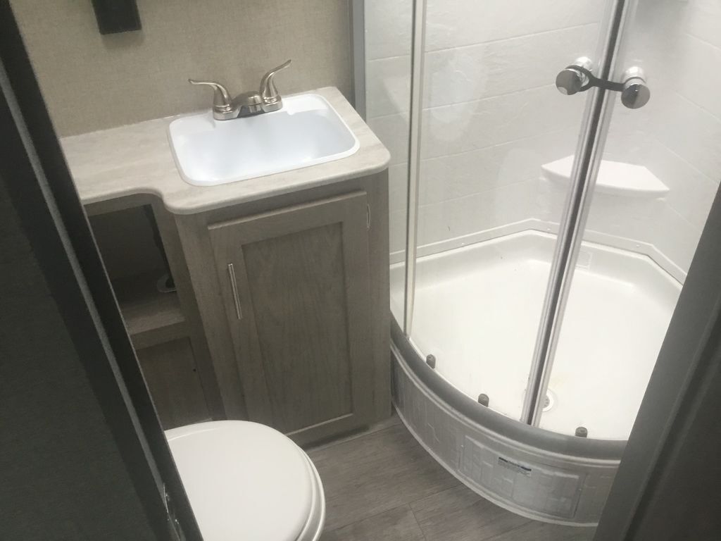 Bathroom with a sink, toilet and a walk-in shower.