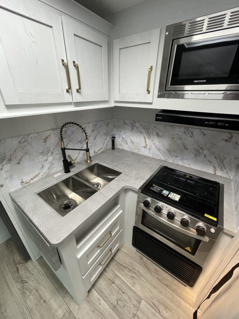 Kitchen with a gas range, oven, sink and cabinets.