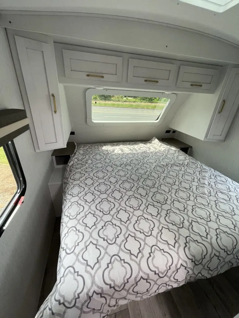 Bedroom with a king size bed, overhead cabinets and shirt closets.