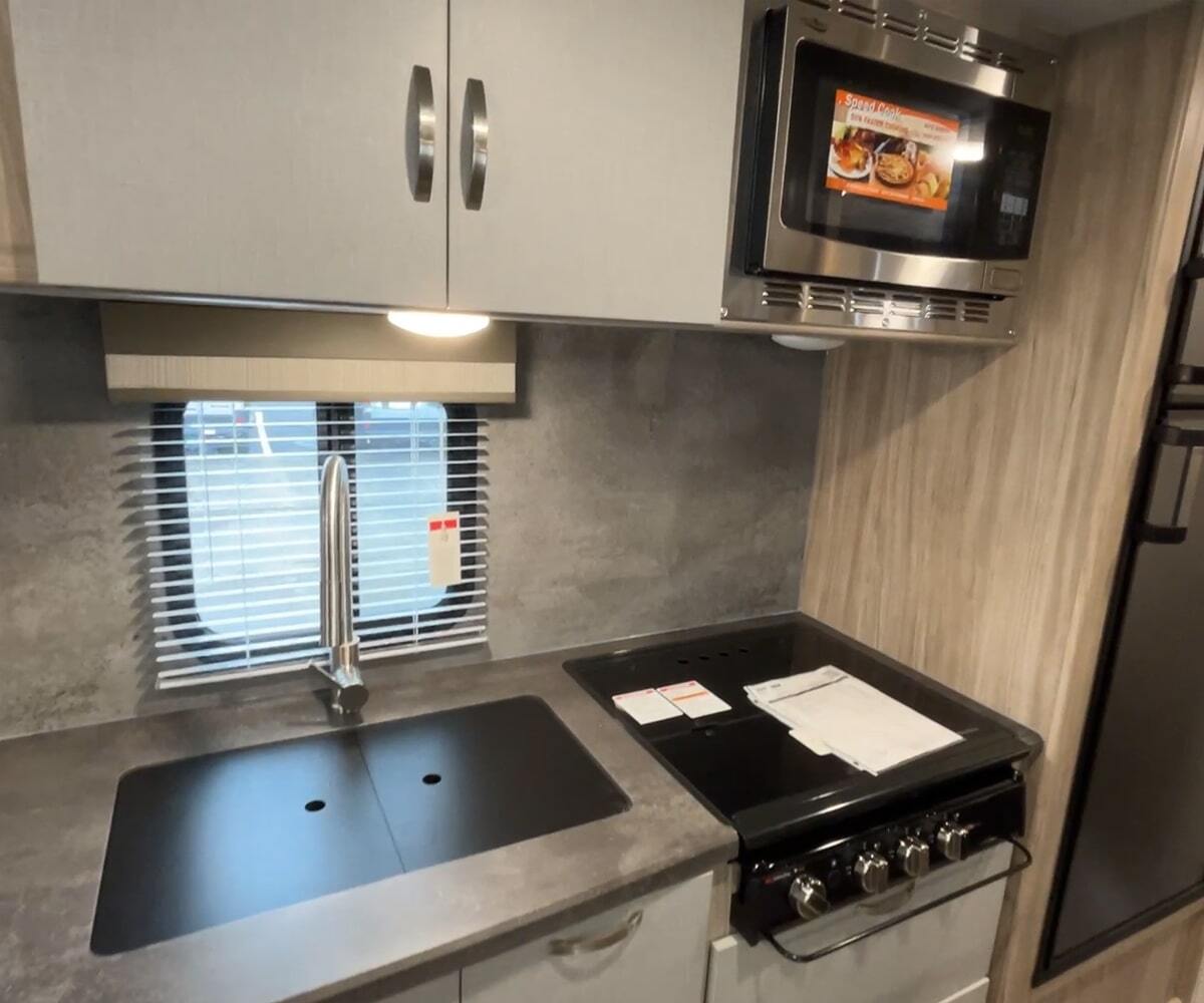 Kitchen with a gas range, fridge, oven, sink and cabinets.