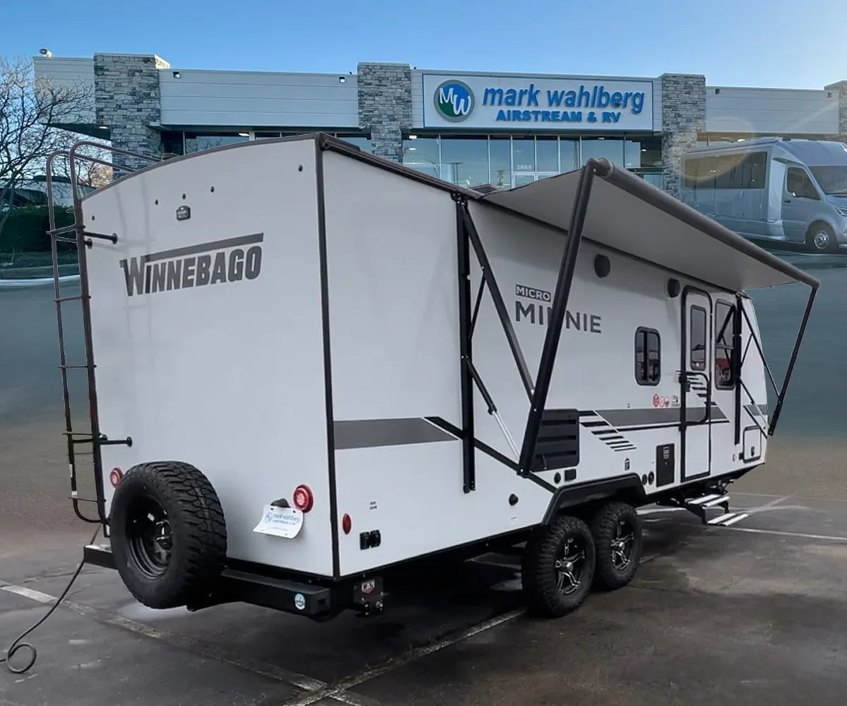 Side view of the RV with an awning.