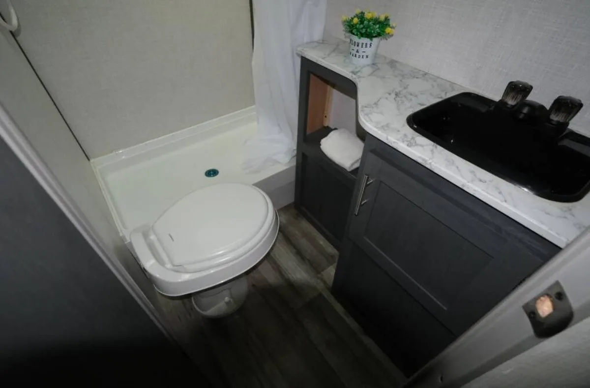 Bathroom with a sink, toilet and a walk-in shower.