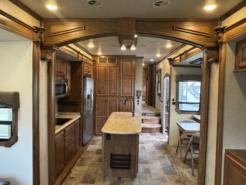 Interior view of the RV with a dinette and a kitchen.