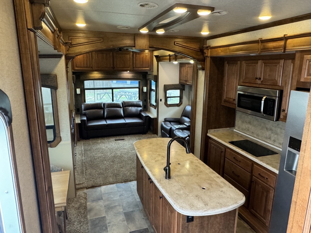 Interior view of the RV with a dinette, living space and a kitchen.