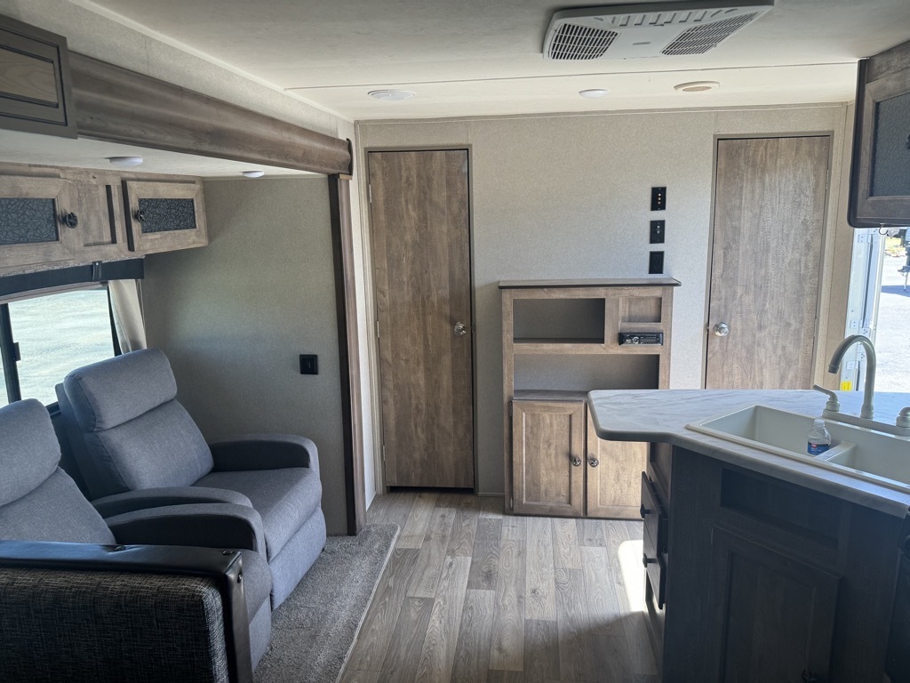 Living space with overhead cabinets.  