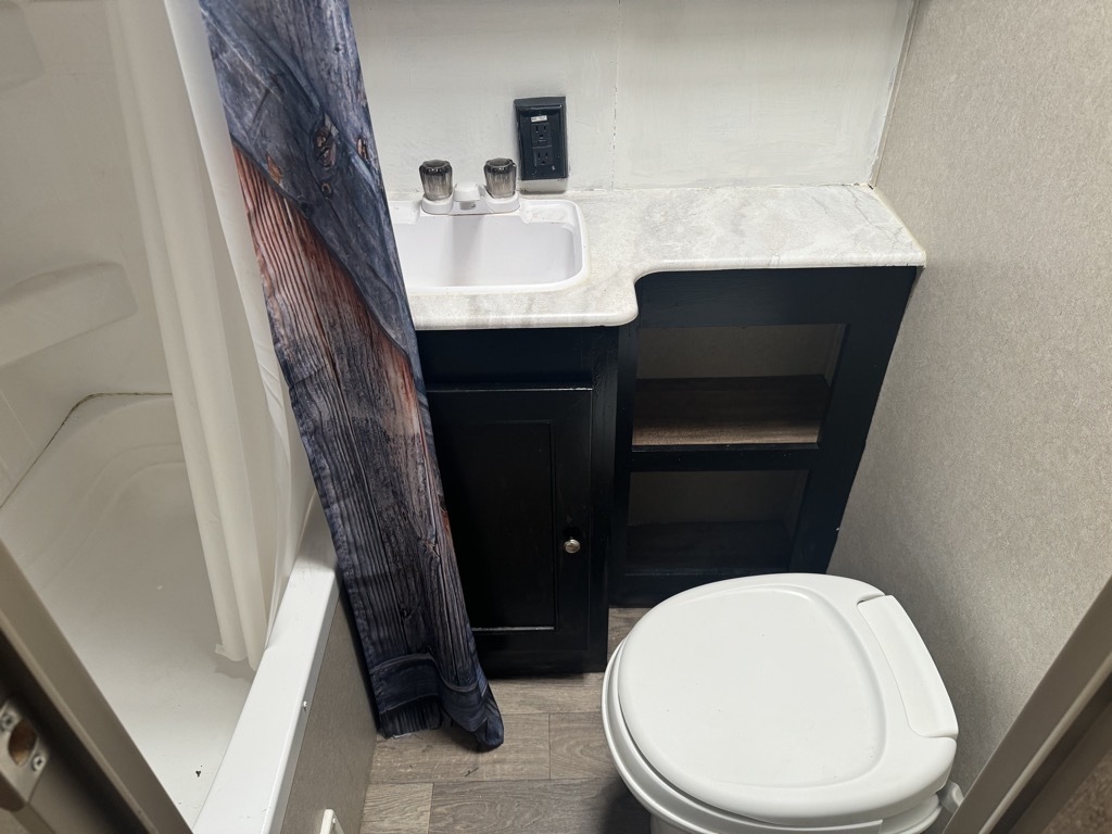 Bathroom with a sink, toilet and a walk-in shower.