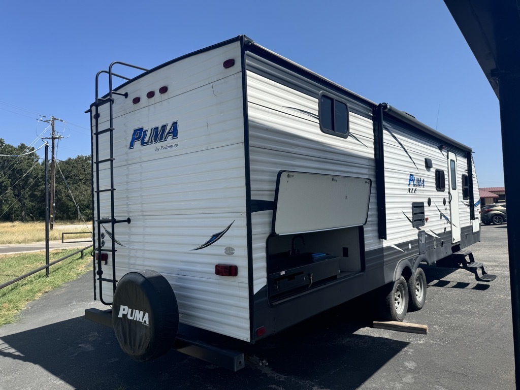 Side view of the RV with an outdoor kitchen.