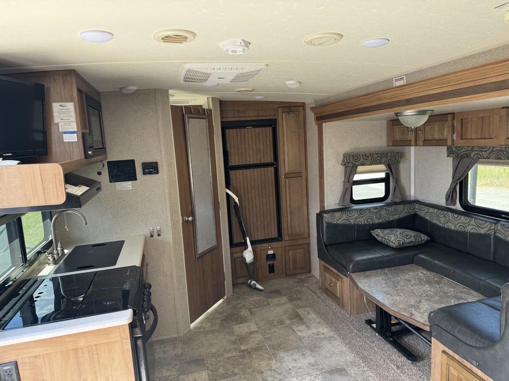 Interior view of the RV with a dinette and a kitchen.