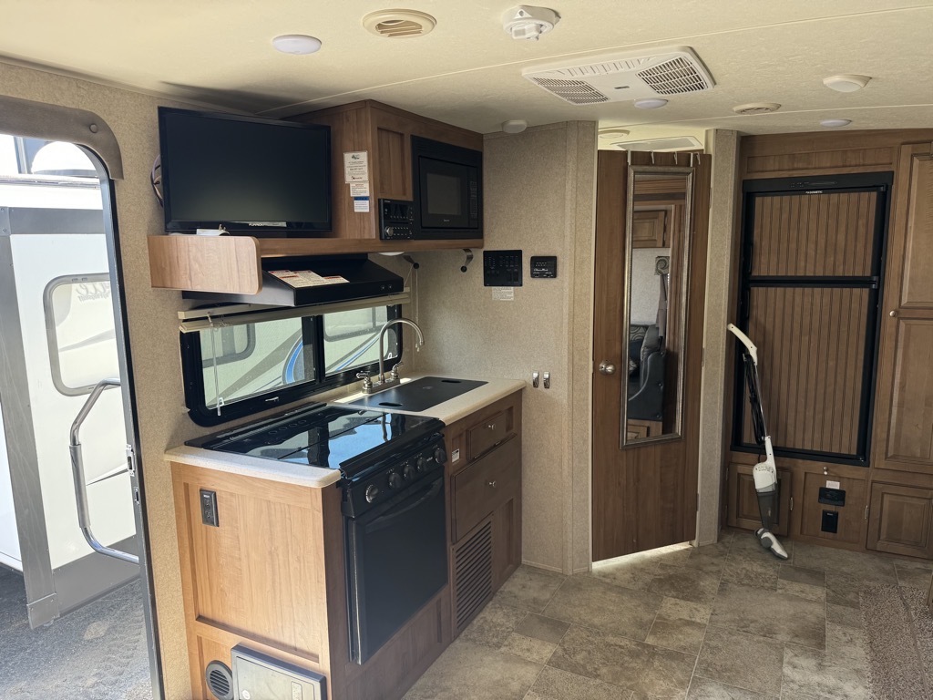 Kitchen with a gas range, oven, sink and cabinets.