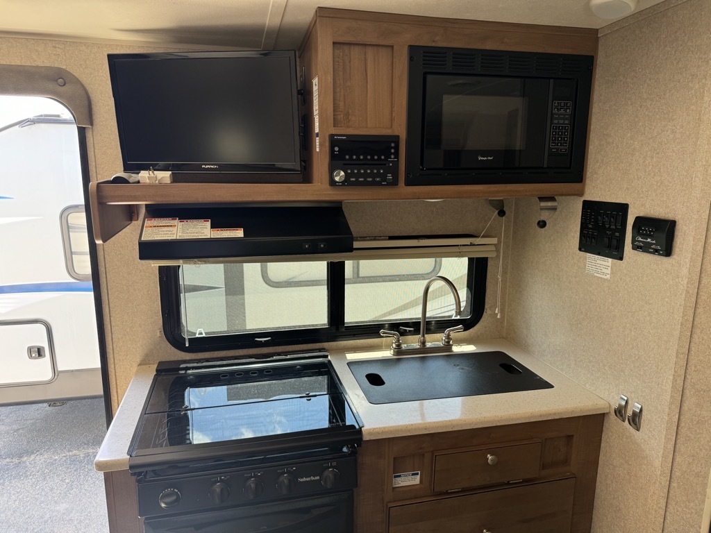 Kitchen with a gas range, oven, sink and cabinets.