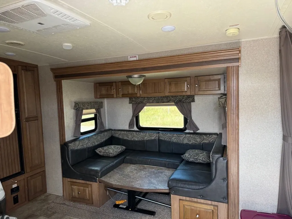 Dinette with pull-out storage drawers and overhead cabinets.