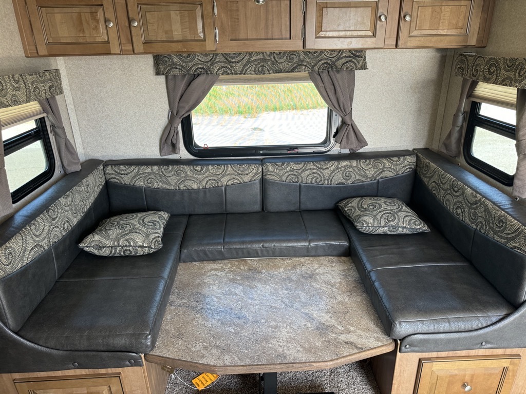 Dinette with pull-out storage drawers and overhead cabinets.