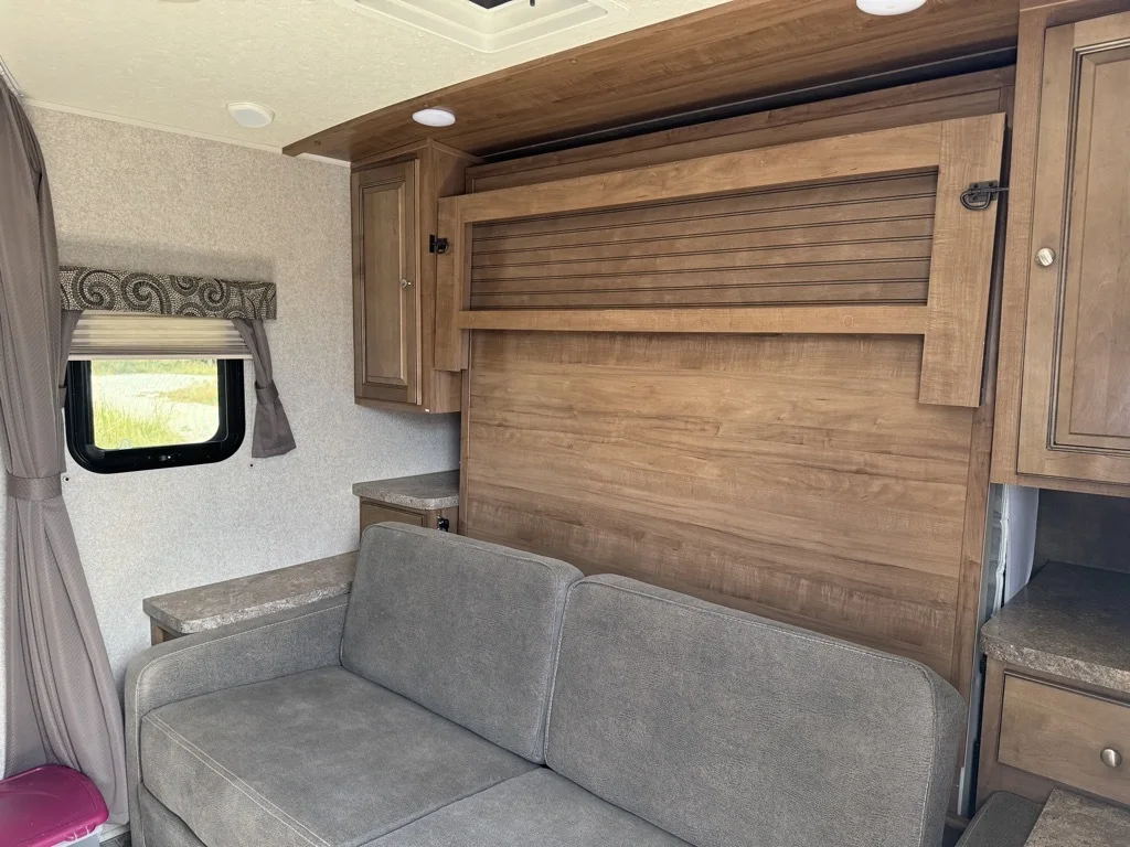 Living space with overhead cabinets. 