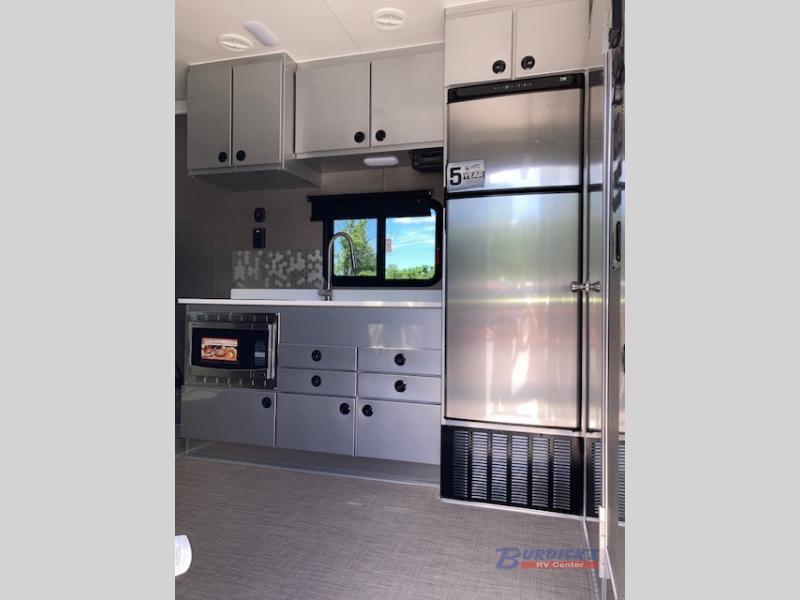 Kitchen with a gas range, fridge, sink and cabinets.