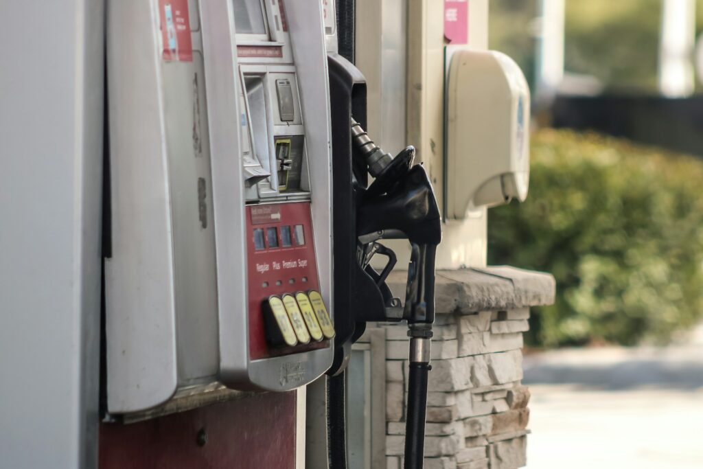  A gas station pump with nozzles hanging in place.