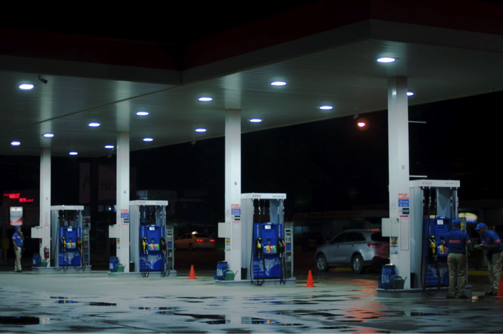 A brightly lit gas station at night.